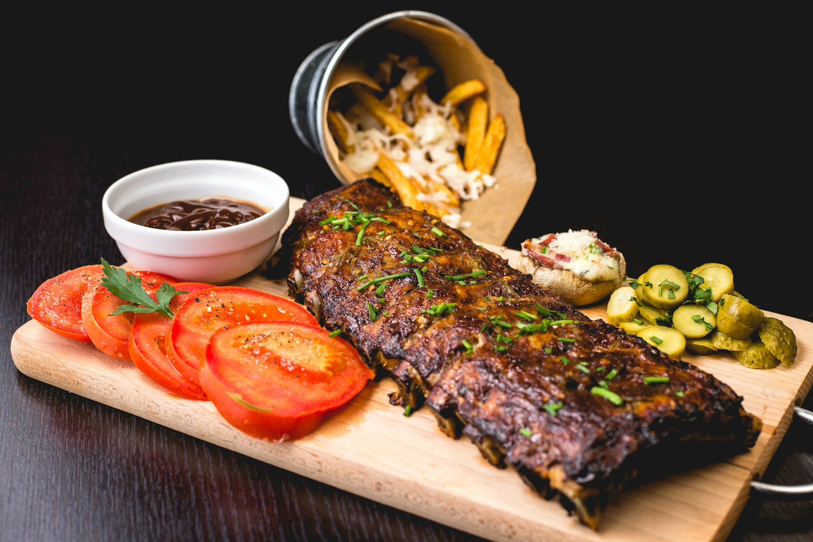Sliced beef with roasted vegetables on a white plate